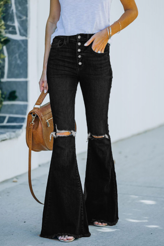 Черные джинсы-клеш с разрезами на коленях и необработанным краем