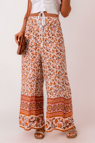 Белые широкие штаны с завязкой на талии и оранжевым цветочным принтом в стиле бохо